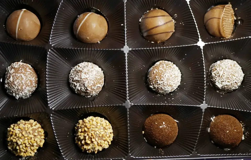 An open box of assorted chocolate truffles.